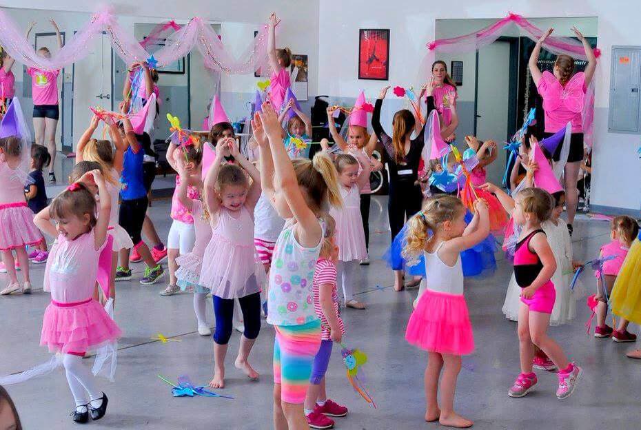 A studio full of little dancers in pink with ribbons and props
