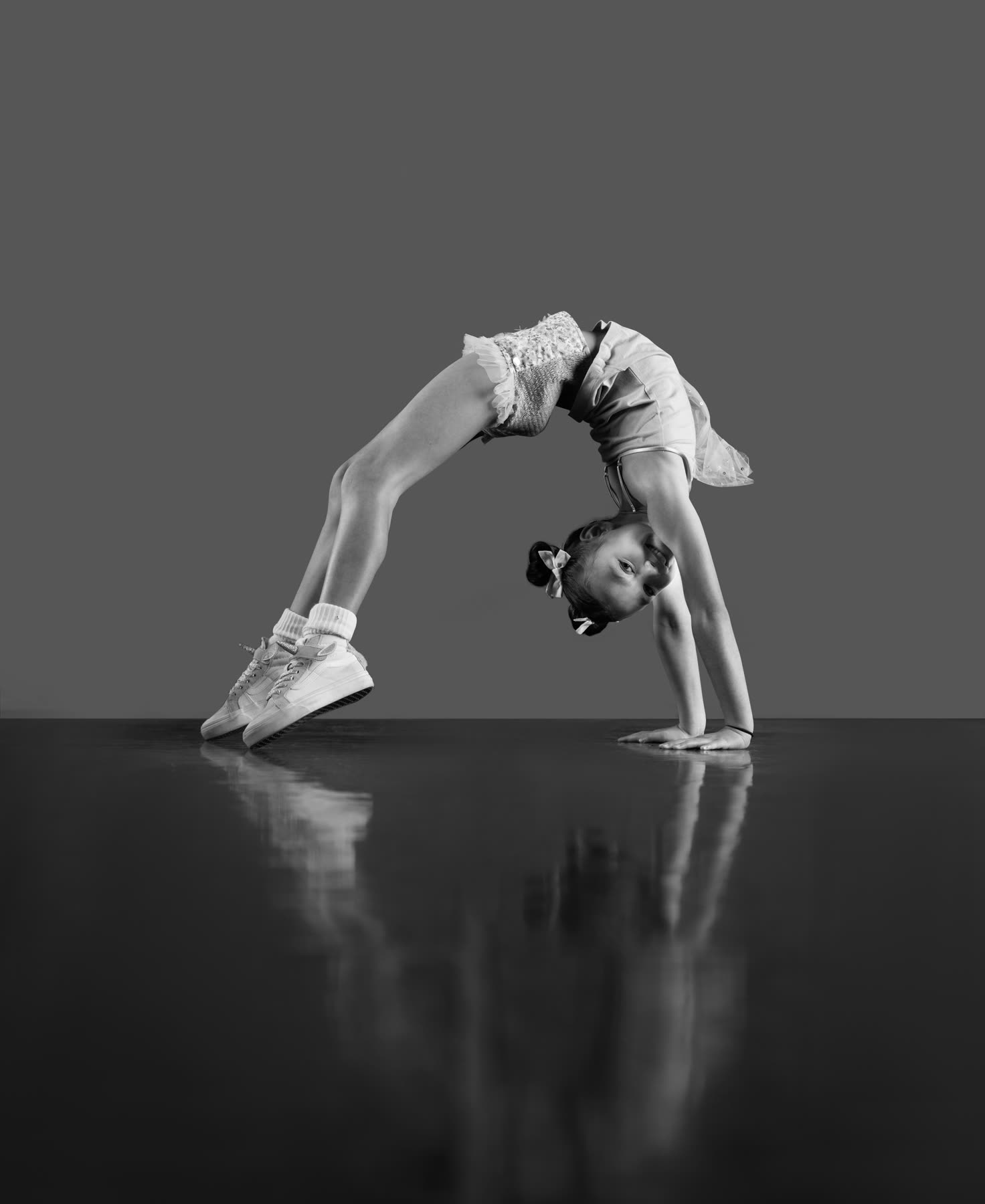 A dancer in a backbend on the studio floor